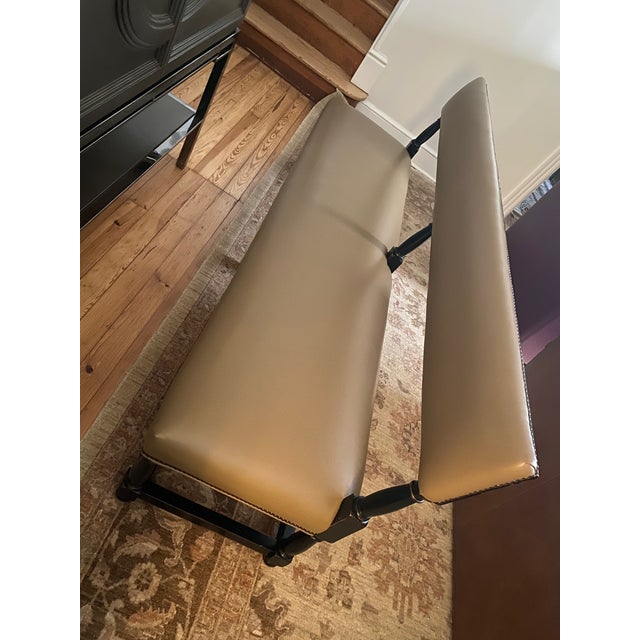 Designer custom made large heavy banquette upholstered in taupe faux leather with Jacobean style walnut base and brass...