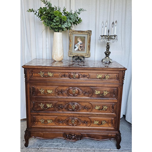 French Louis XV style commode chest, carved walnut and marble-top . Featuring ornate gilt metal hardware and classical...