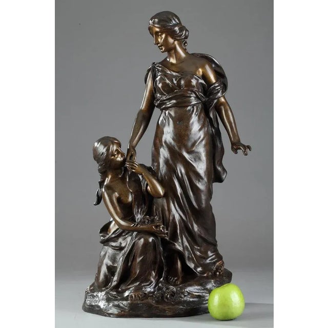 Late 19th century bronze group featuring two young women with flowers on a small naturalistic terrace. Signed on the...