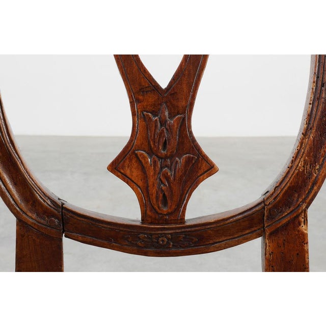 An elegant 18th‑century Gustavian-style chair crafted in walnut and upholstered in leather. This refined piece blends the...
