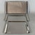 A simple and refined serving set consisting of three stackable rectangular stainless steel trays, authentically marked...