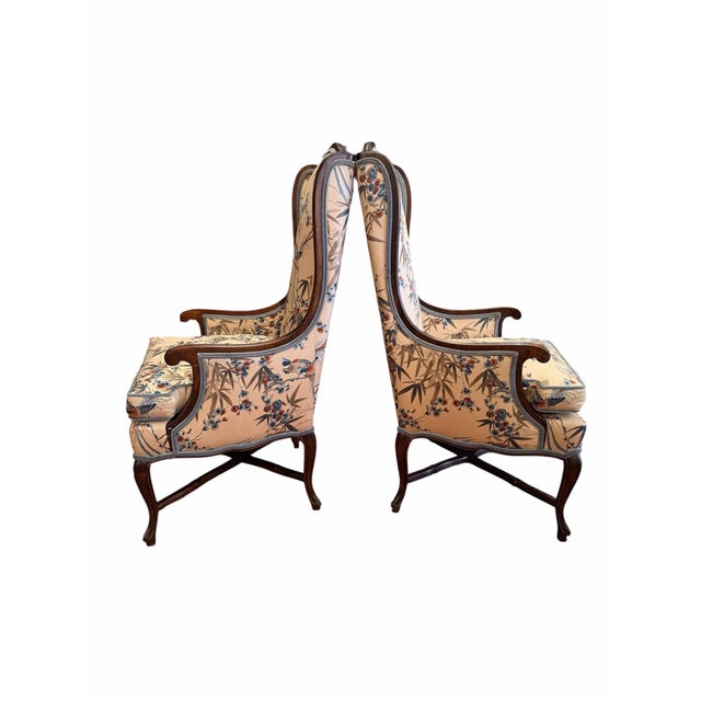 A distinctive pair of vintage wingback Bergère armchairs by Century Chair Company of Hickory, North Carolina, upholstered...