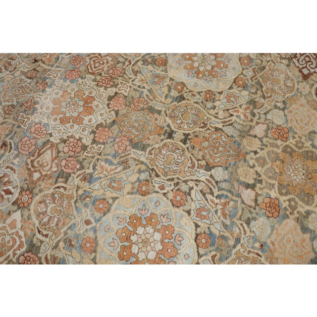 An oversize neutral-colored Persian Bakhtiari rug, circa 1920. Measures: 13'7'' x 20'.