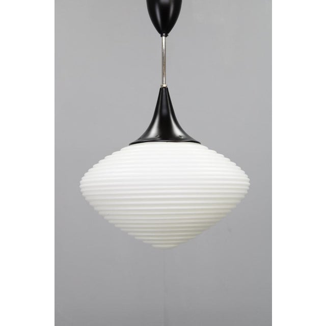 A refined mid-century modern pendant light produced in czechoslovakia in the 1970s by kamenický šenov, one of europe’s...