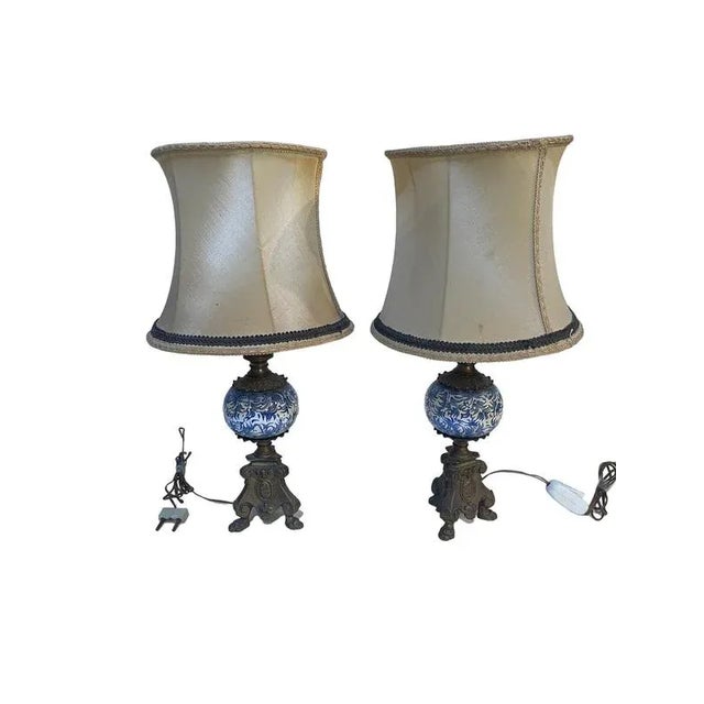 Pair of 20th-century ceramic and bronze table lamps A refined pair of table lamps, made of ceramic decorated with blue and...