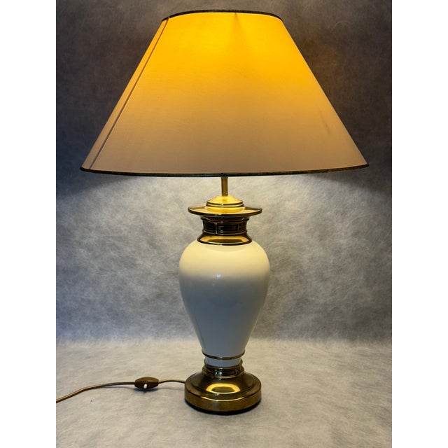 A refined Italian table lamp from the 1970s, featuring a sculptural glazed ceramic body complemented by elegant brass...