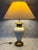 A refined Italian table lamp from the 1970s, featuring a sculptural glazed ceramic body complemented by elegant brass...