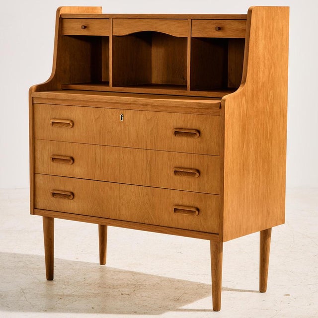 Danish oak bureau desk in restored condition with five drawers and extendable writing board and mirror. The furniture has...