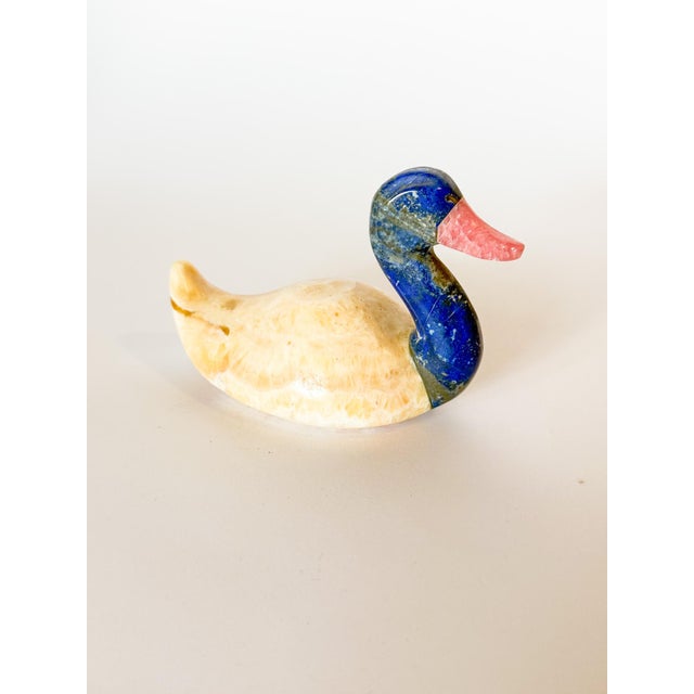 The most charming little duck carved to perfection out of sparkling blue lapis lazuli, and what we believe to be pink...
