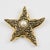 This elegant Guy Laroche Paris pin brooch features an oversized starfish shape in gilt metal, ornately carved and...