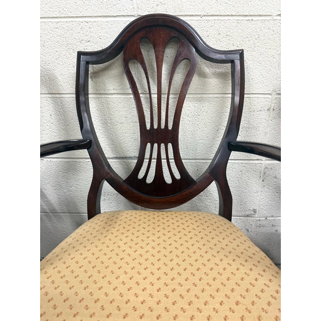 This is a stunning full set of six antique Hepplewhite or Duncan Phyfe style mahogany dining chairs including one arm...