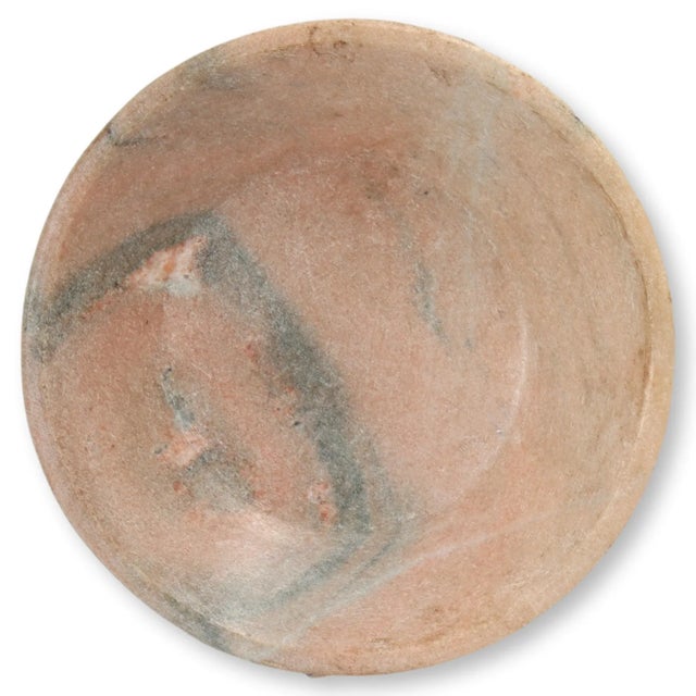 Honed marble bowl with unusual natural pink coloring and heavy gray veining. No maker's mark.