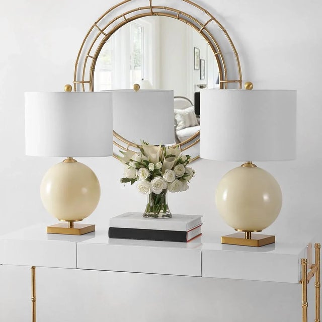 Illuminate your space with the elegant Anina, a set of two 24 inch cream glass table lamps. These lamps offer a perfect...