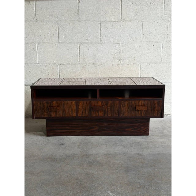 This beautiful low-profile chest presents a rectangular silhouette sitting on a recessed plinth base. Three stacked...