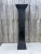 A vintage architectural element column pedestal with simple ornamentation and painted in a satin black. The pedestal is...