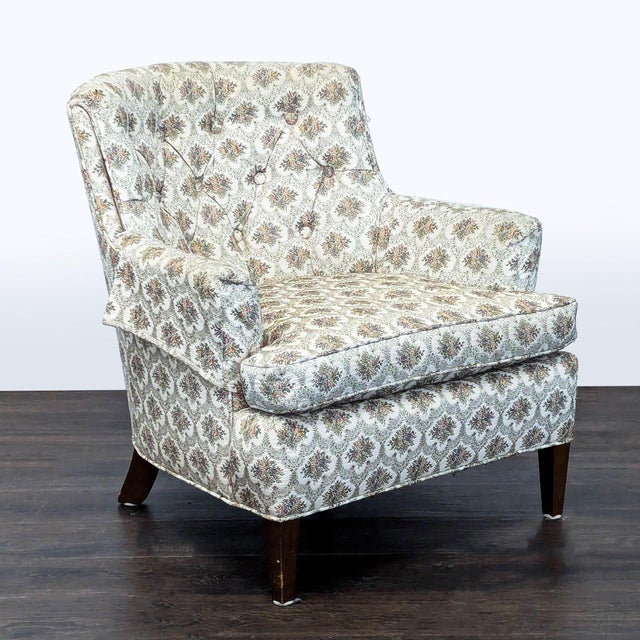 Add comfort and character to your space with this vintage lounge chair. It features a soft cushioned seat, sturdy wooden...
