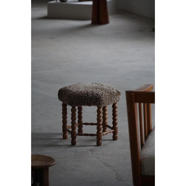 This elegant stool is a refined example of Danish Modern design, crafted by a skilled Danish cabinetmaker in the 1950s....