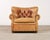 A richly patinated signed Ralph Lauren Home Writer's Chair paired with a matching Ralph Lauren Writer's Ottoman. The...