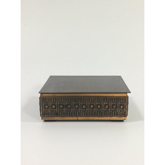 Bronze cigarette box with unique pattern on the side, and wooden inlay. Ideal for storing business cards, jewelry or...
