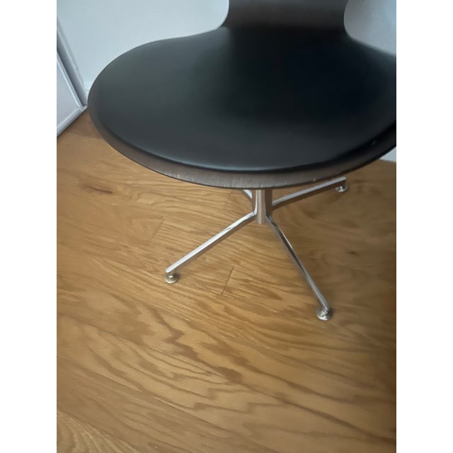 Mid century walnut and leather swiveling chair made in Denmark.. I bought it in an auction ! Very comfortable