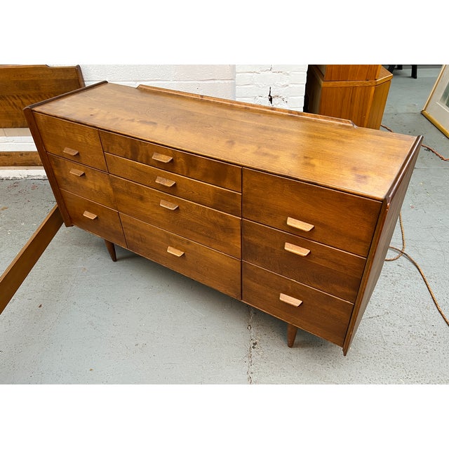 This vintage mid-century modern lowboy dresser was designed by Russel Wright for the Conant Ball Company. Please confirm...