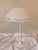 A generously sized, minimalist table lamp in a postmodern design. Slender base made of white lacquered metal, large,...