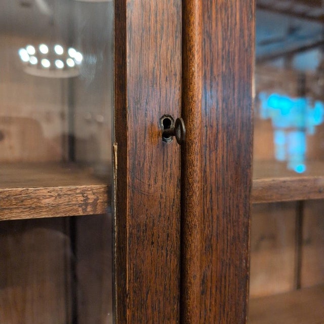 A lustrous Georgian oak glazed dresser. Rich in color, the dark oak of this dresser is complimented by the brass hardware...