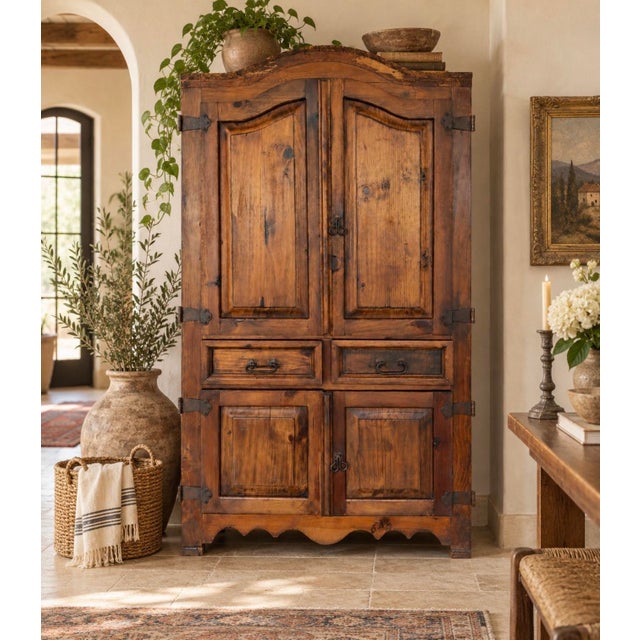 Warm and character-rich vintage Mexican pine armoire featuring Spanish Colonial / hacienda-inspired styling, paneled...