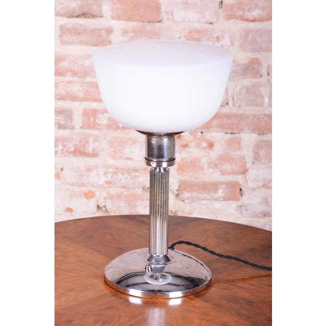 This elegant table lamp is a classic example of the Bauhaus style, manufactured in Czechoslovakia. It dates back to the...