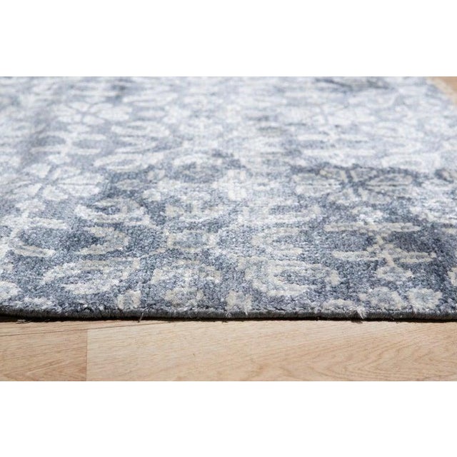 This gray viscose rug features a hand knotted pile construction that aligns with the EORC Rugs style. It serves as a...