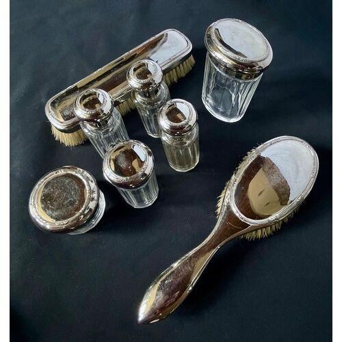 Set of eight vintage chrome vanity pieces. Long brush measures: 7.38"L × 2"W × 1.63"H. Hand brush measures: 8.75"L ×...