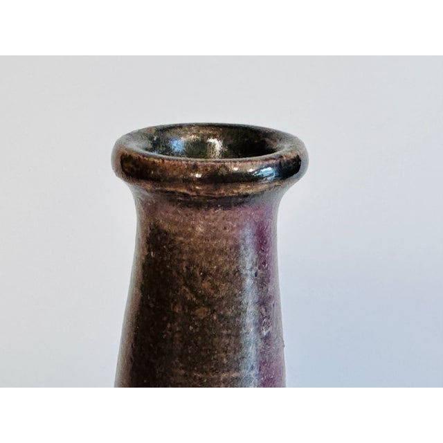 Handcrafted bottle-neck vase by Jürgen Riecke (1927-1997), created in the 1960s. The characteristic ruby-red-brown glaze...