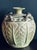 Vintage Pier 1 green vase featuring a weathered, matte green glaze, tropical leaf relief, faux rattan handles, and a...