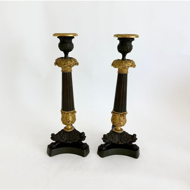 Elegant and stately early 19th century French Restoration period circa 1825-1835 neoclassical candlesticks showcase the...