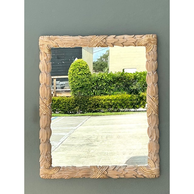 This vintage carved wood wall mirror is a striking example of artisan craftsmanship, featuring an elaborate frame adorned...