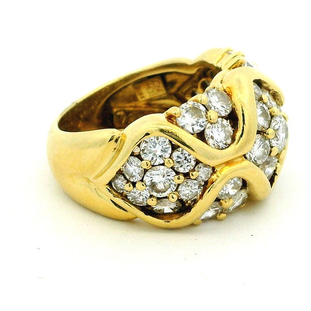 A substantial and beautifully executed signed José Hess diamond bombe ring crafted in 18K yellow gold. This richly...