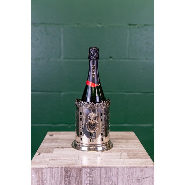A lovely example of a late 19th century silver plated wine bottle holder from England. Originally designed to hold wine...