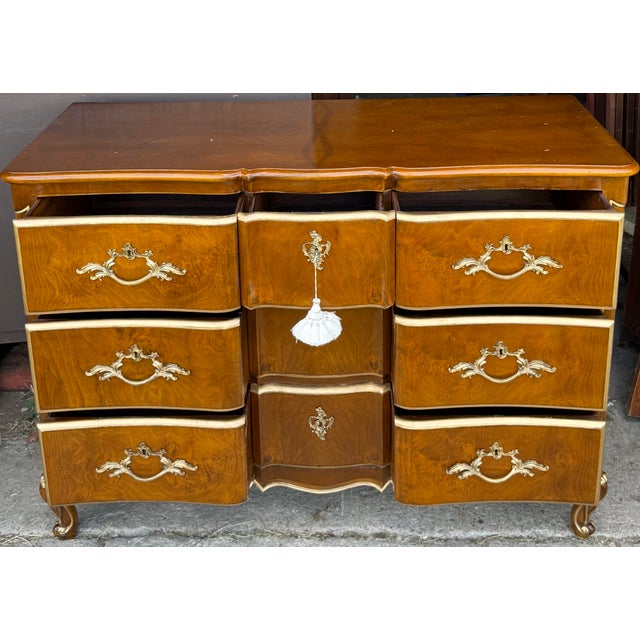 Hand gilded details elevate this stunning walnut dresser/chest by Scott Thomas. Features seven dovetailed drawers (only...