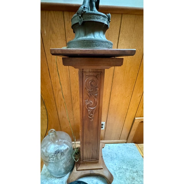 This vintage figural table lamp features a sculptural female figure with a dark patinated finish, mounted on a carved wood...