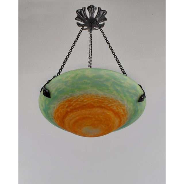 Daum freres & Louis Majorelle A wonderful French art deco hanging fixture in wrought iron with a Daum bowl in mottled...