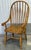 Sturdy set of solid oak chairs by Virginia house. Chairs feature a bowed back with spindles , turned legs and a demi lune...