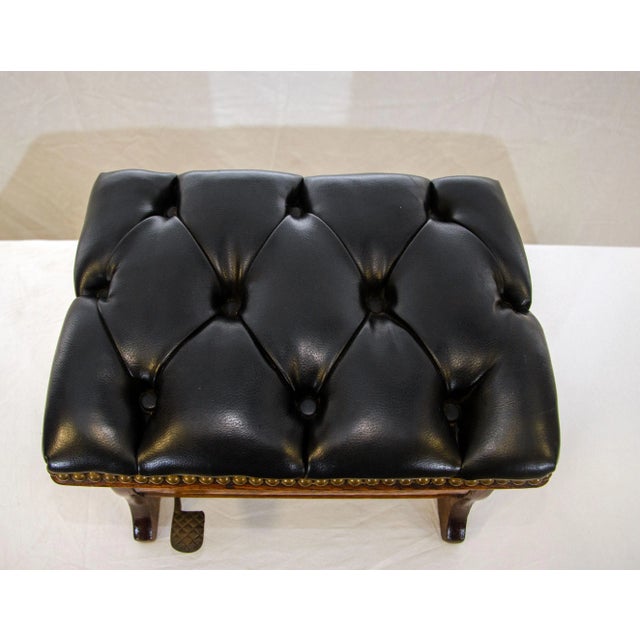 An unusual small footstool that has a top that lifts with a foot pedal to reveal a porcelain waste container, the...