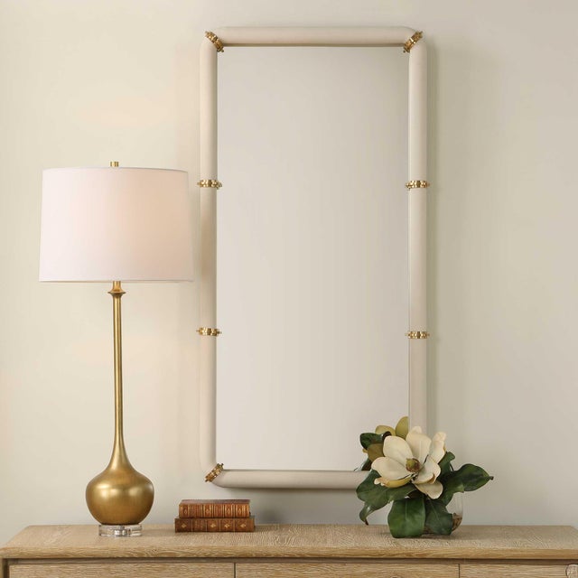 The Cyprus Mirror Showcases A White Faux Shagreen Leather Wrap Featuring Brass Plated Steel Bands That Help Elevate This...