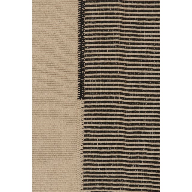 Handwoven in wool, this 5x7 Rez Kilim features a finely striped central panel framed by expansive ivory fields. Its...