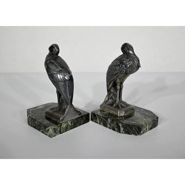 Bookend featuring herons in patinated metal on a sea green marble base. This is a work by Maurice Frécourt (1890-1961) who...
