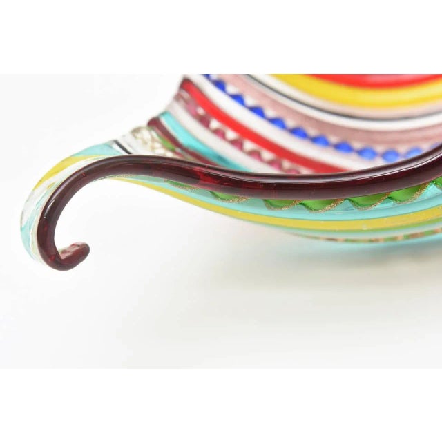 The amazing colors of this sculptural vintage masterpiece of a Murano hand blown glass bowl rings with great technical...