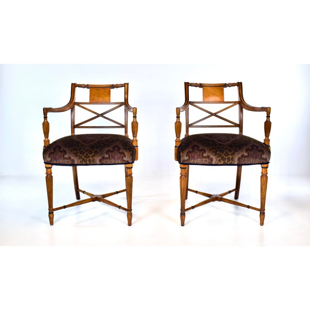 A pair of English Regency-style armchairs with x-shaped backs, burl splats, multiple reeded & tapered carved turnings...