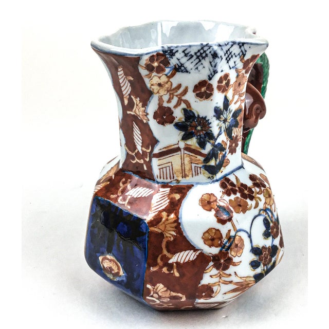 Antique Japanese Imari pitcher or ewer, decorated in iron red enamel and green serpent handle on underglazed blue. Some...