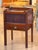 Mahogany bedside commode with a raised gallery top, shaped corner posts, and a tambour front panel above a single drawer...
