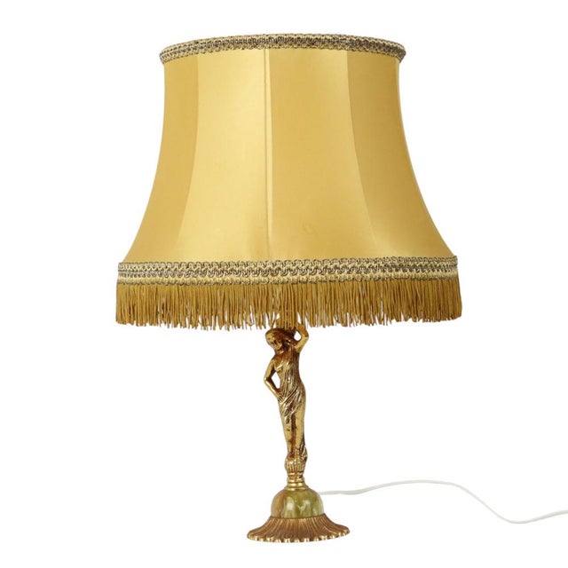 Lovely vintage table lamp with matching fringed shade, made of brass and onyx marble. The piece is executed in Art Nouveau...